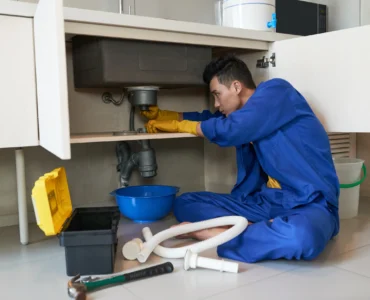 asian-plumber-blue-overalls-clearing-blockage-drain_result